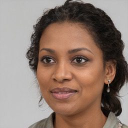 Joyful black young-adult female with medium  brown hair and brown eyes