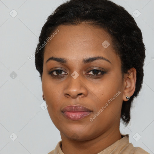 Joyful black young-adult female with short  black hair and brown eyes