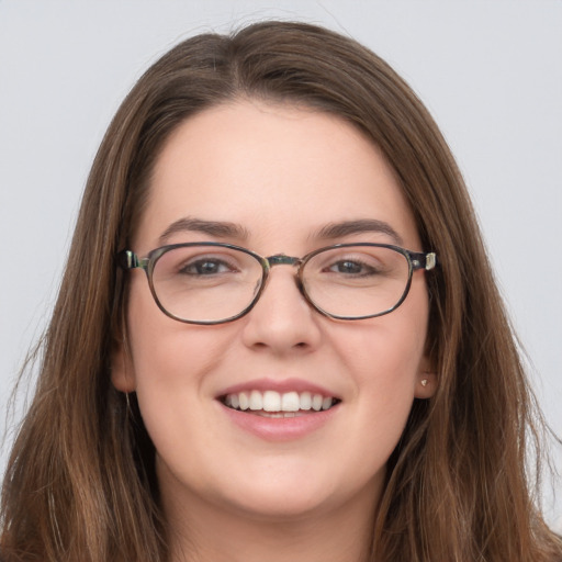 Joyful white young-adult female with long  brown hair and grey eyes