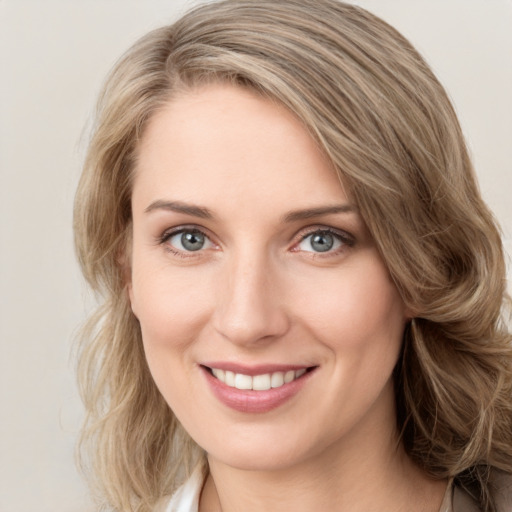 Joyful white young-adult female with medium  brown hair and green eyes