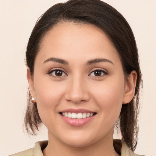 Joyful white young-adult female with medium  brown hair and brown eyes