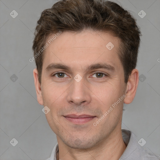 Joyful white young-adult male with short  brown hair and grey eyes