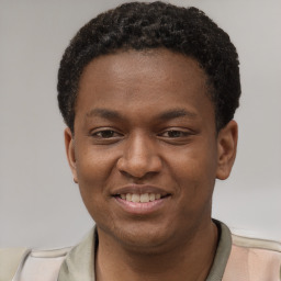 Joyful latino young-adult male with short  brown hair and brown eyes