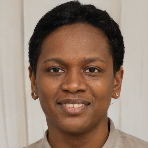 Joyful black young-adult female with short  black hair and brown eyes