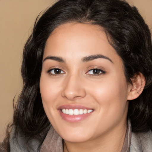 Joyful white young-adult female with medium  black hair and brown eyes