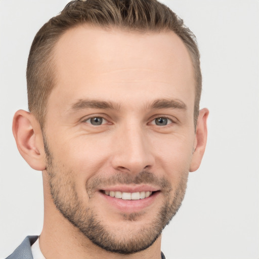 Joyful white young-adult male with short  brown hair and brown eyes