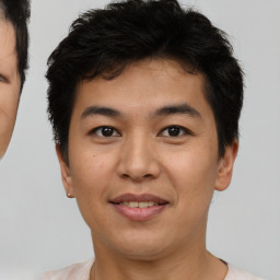 Joyful asian young-adult male with short  brown hair and brown eyes