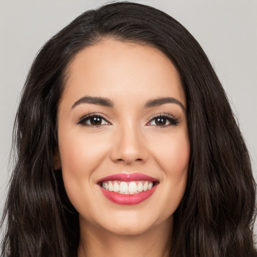 Joyful white young-adult female with long  black hair and brown eyes