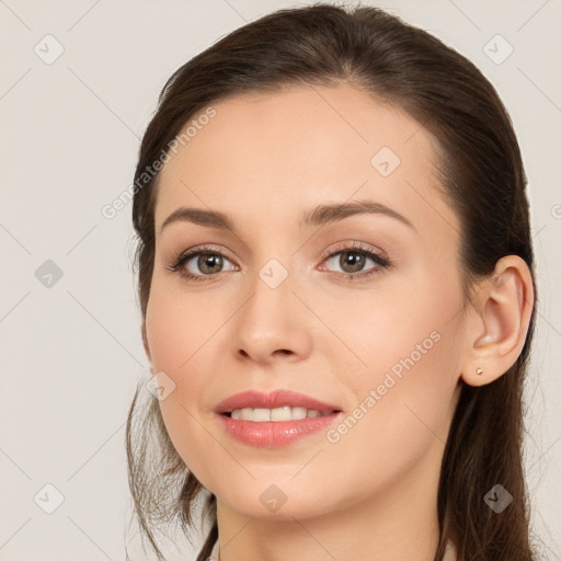 Joyful white young-adult female with long  brown hair and brown eyes