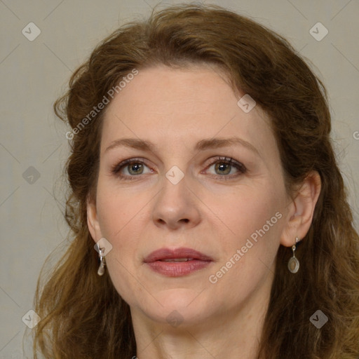 Joyful white adult female with long  brown hair and green eyes