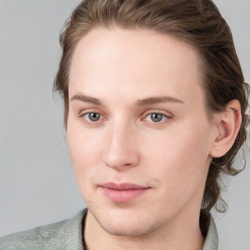 Joyful white young-adult female with medium  brown hair and blue eyes