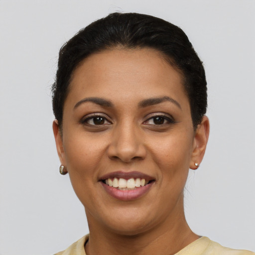 Joyful latino young-adult female with short  brown hair and brown eyes