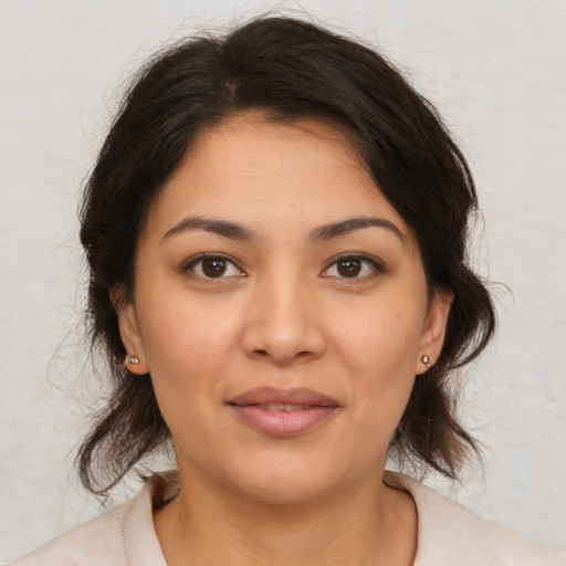 Joyful latino young-adult female with medium  brown hair and brown eyes