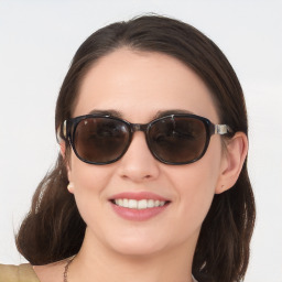 Joyful white young-adult female with medium  brown hair and blue eyes