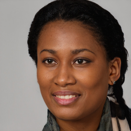 Joyful black young-adult female with medium  black hair and brown eyes