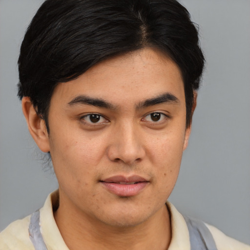 Joyful asian young-adult male with short  brown hair and brown eyes