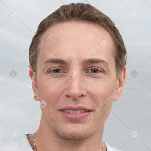 Joyful white adult male with short  brown hair and grey eyes