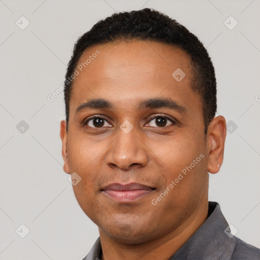 Joyful black young-adult male with short  black hair and brown eyes