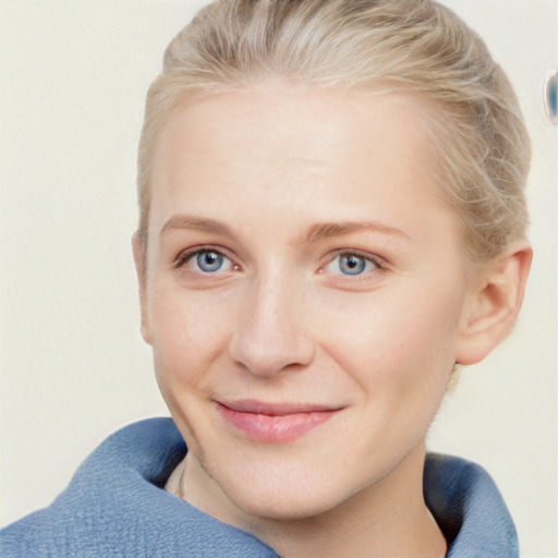 Joyful white young-adult female with short  brown hair and blue eyes