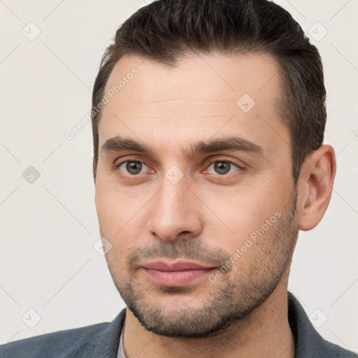 Joyful white young-adult male with short  brown hair and brown eyes