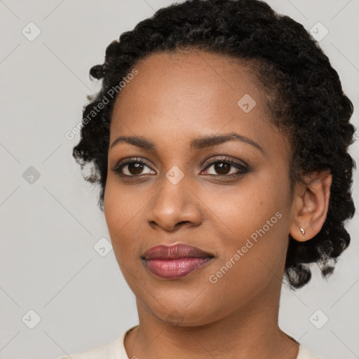 Joyful black young-adult female with short  black hair and brown eyes