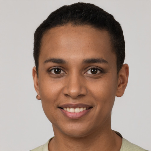 Joyful black young-adult female with short  black hair and brown eyes