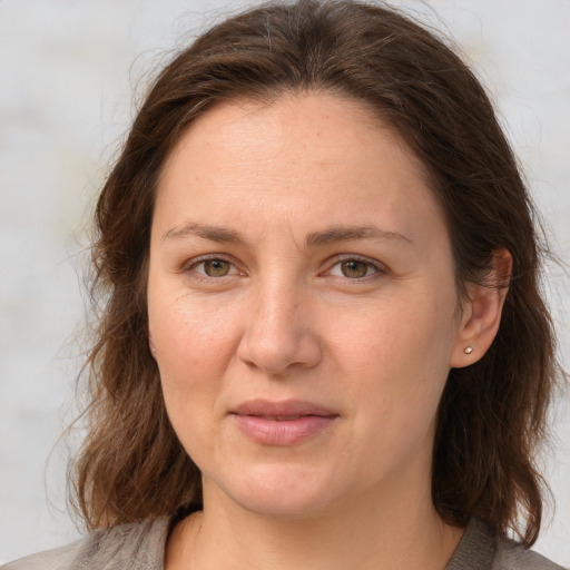 Joyful white adult female with medium  brown hair and grey eyes