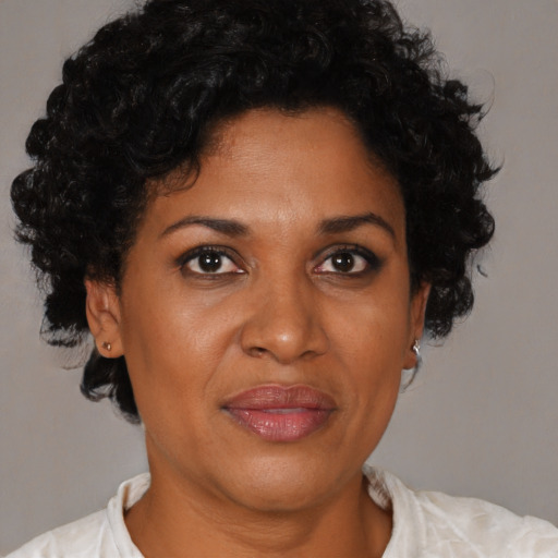 Joyful black adult female with short  brown hair and brown eyes