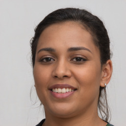 Joyful latino young-adult female with medium  brown hair and brown eyes