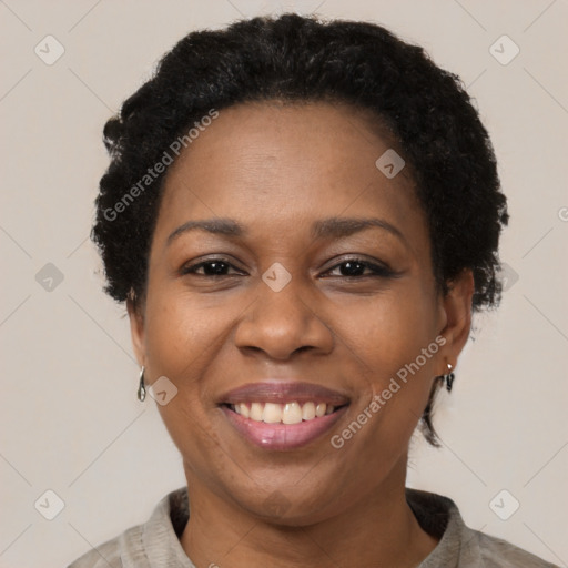 Joyful black adult female with short  brown hair and brown eyes