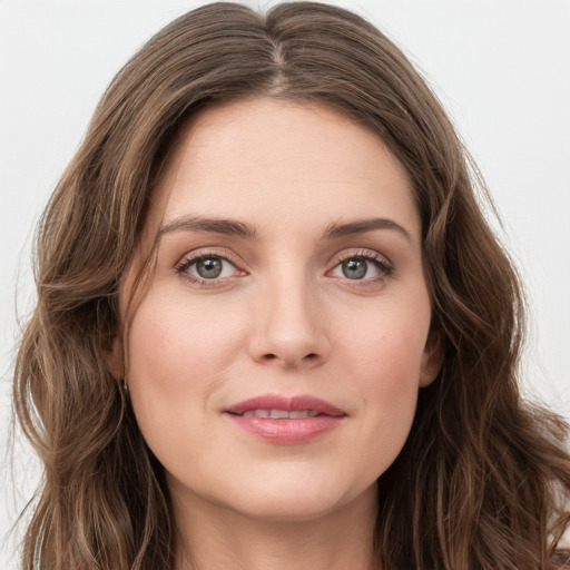 Joyful white young-adult female with long  brown hair and green eyes