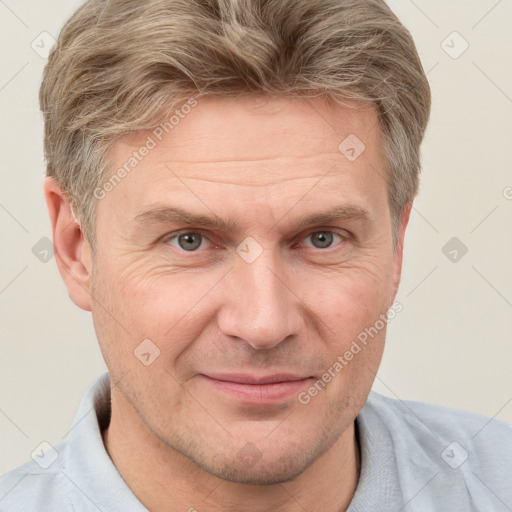 Joyful white adult male with short  brown hair and grey eyes