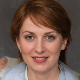 Joyful white young-adult female with medium  brown hair and blue eyes