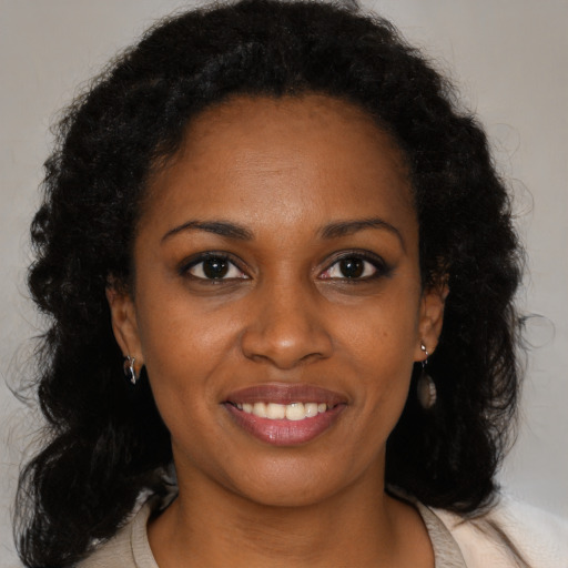 Joyful black young-adult female with medium  brown hair and brown eyes