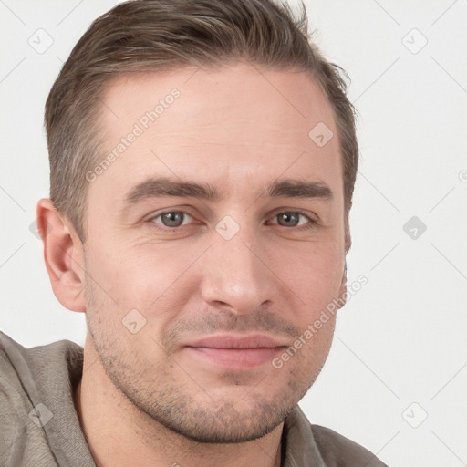 Joyful white young-adult male with short  brown hair and grey eyes