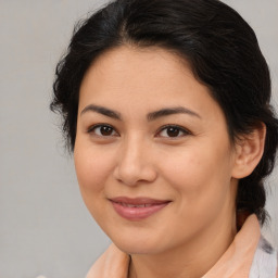 Joyful latino young-adult female with medium  brown hair and brown eyes