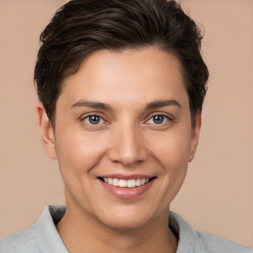 Joyful white young-adult female with short  brown hair and brown eyes