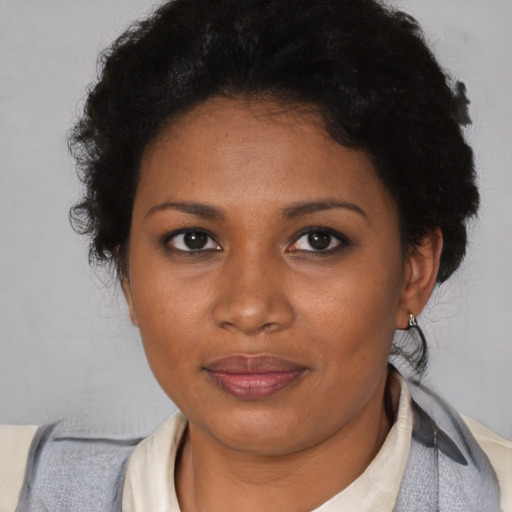 Joyful black adult female with short  brown hair and brown eyes