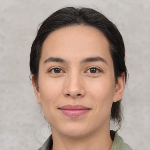 Joyful white young-adult female with medium  black hair and brown eyes