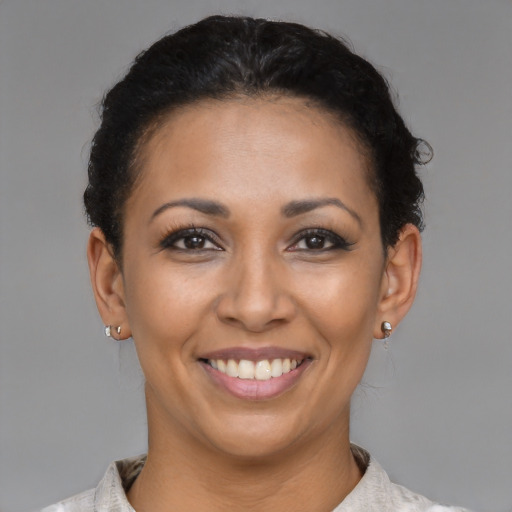 Joyful latino young-adult female with short  brown hair and brown eyes