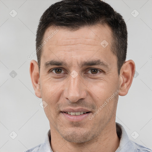 Joyful white adult male with short  brown hair and brown eyes