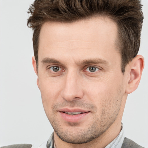 Joyful white adult male with short  brown hair and grey eyes