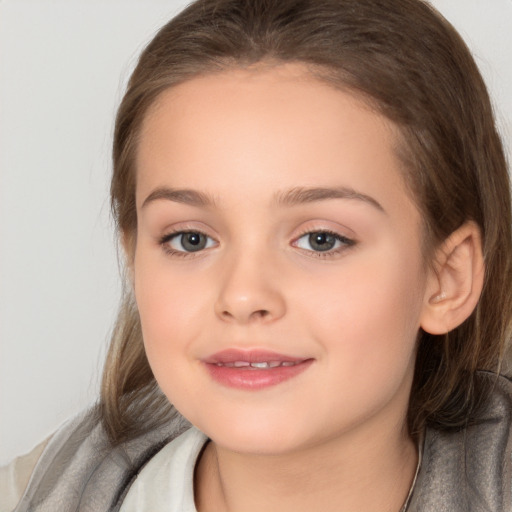 Joyful white child female with medium  brown hair and brown eyes