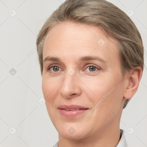 Joyful white adult female with short  brown hair and grey eyes