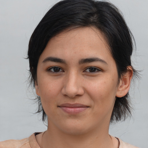Joyful latino young-adult female with medium  brown hair and brown eyes