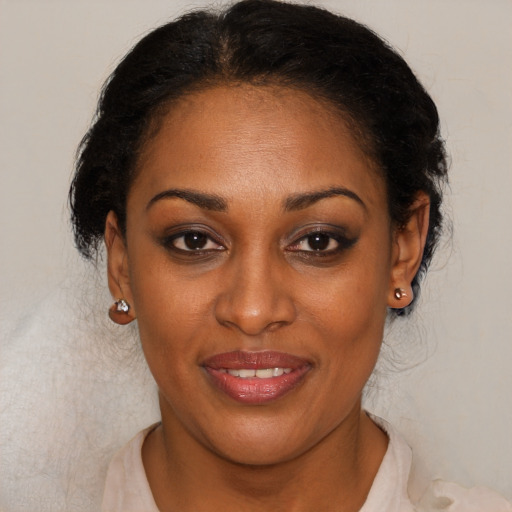 Joyful black young-adult female with short  brown hair and brown eyes