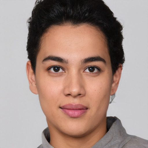 Joyful latino young-adult male with short  brown hair and brown eyes