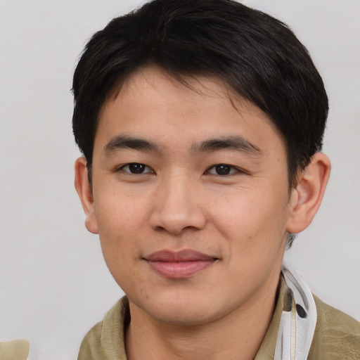 Joyful asian young-adult male with short  brown hair and brown eyes