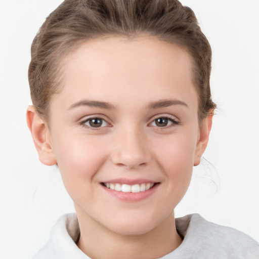 Joyful white child female with short  brown hair and brown eyes