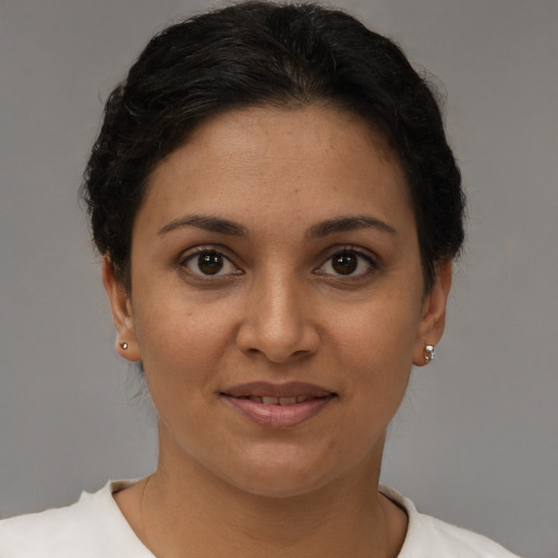 Joyful latino young-adult female with short  brown hair and brown eyes